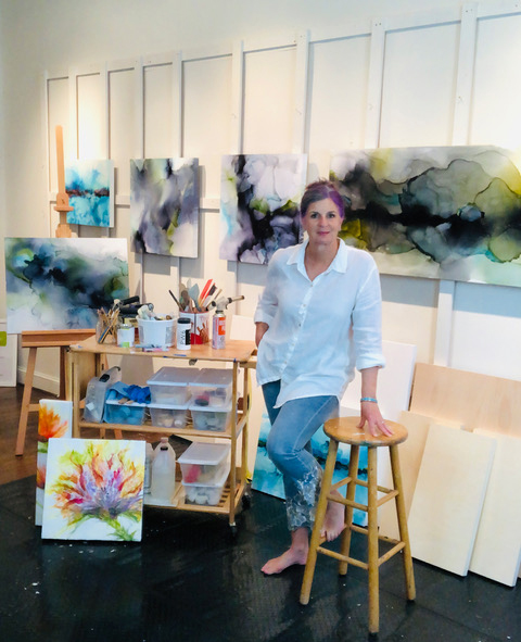 Deborah Llewellyn with her paintings